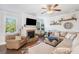 Inviting living room featuring a stone fireplace, comfortable seating, and natural light at 408 Honeybee Ln, Canton, GA 30115