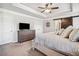 Tranquil main bedroom with decorative ceiling, TV, barn door, and neutral decor at 408 Honeybee Ln, Canton, GA 30115
