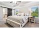 Well-lit main bedroom with a barn door leading to the bath and large windows at 408 Honeybee Ln, Canton, GA 30115