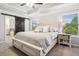 Serene main bedroom featuring a trey ceiling, a barn door, and abundant natural light from the window at 408 Honeybee Ln, Canton, GA 30115