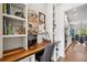 Efficient office nook with custom built-in desk and shelving adjacent to a bright kitchen at 408 Honeybee Ln, Canton, GA 30115
