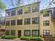 Back of building with lots of windows and greenery at 53 Monet Nw Ct, Atlanta, GA 30327