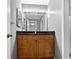 Bathroom vanity with wood cabinets and a black countertop at 53 Monet Nw Ct, Atlanta, GA 30327