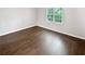 Bedroom featuring hardwood floors and a large window at 53 Monet Nw Ct, Atlanta, GA 30327