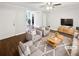 Staged living room featuring hardwood floors, plush seating, and natural light at 53 Monet Nw Ct, Atlanta, GA 30327