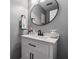 Modern bathroom features an oval mirror, white vanity, and matte black fixtures at 135 N North River Dr, Atlanta, GA 30350