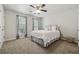 Cozy bedroom with neutral carpet, ceiling fan, and window bringing in natural light at 135 N North River Dr, Atlanta, GA 30350