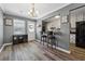 Dining room with wood-look floors and view into the kitchen with a bar and seating at 135 N North River Dr, Atlanta, GA 30350