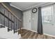 Cozy entryway with wood-look floors, and staircase with traditional wood and iron accents at 135 N North River Dr, Atlanta, GA 30350