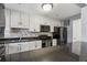 Modern kitchen with stainless steel appliances, granite countertops, and white cabinetry at 135 N North River Dr, Atlanta, GA 30350