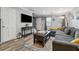 Comfortable living room featuring ample natural light, a large sectional, and a TV at 135 N North River Dr, Atlanta, GA 30350