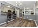 Stylish dining area featuring hardwood floors, gray walls, and an eat-in bar looking into the kitchen at 135 N North River Dr # G, Atlanta, GA 30350