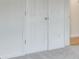 Neutral bedroom featuring gray carpet and white doors at 229 Brookview Pl, Woodstock, GA 30188