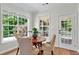 Bright dining area featuring hardwood floors, a door to an outdoor space, and large windows offering ample natural light at 229 Brookview Pl, Woodstock, GA 30188