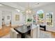 Dining room with modern chandelier, table with seating for six, and ample natural light at 229 Brookview Pl, Woodstock, GA 30188