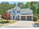Charming two-story home with a well-manicured lawn and a two-car garage at 229 Brookview Pl, Woodstock, GA 30188