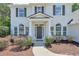 Inviting home entrance with a covered porch and manicured landscaping at 229 Brookview Pl, Woodstock, GA 30188