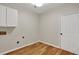Laundry room with cabinets, washer hookups and direct access to outside at 229 Brookview Pl, Woodstock, GA 30188