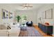 Bright living room with stylish furniture, ceiling fan, and large window for natural light at 229 Brookview Pl, Woodstock, GA 30188