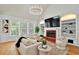 Cozy living room features a fireplace, built-in shelves, and ample natural light at 229 Brookview Pl, Woodstock, GA 30188