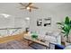 Upstairs living room features a ceiling fan, stylish furniture, and is filled with natural light at 229 Brookview Pl, Woodstock, GA 30188
