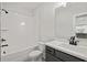 Bathroom with modern fixtures, including a tiled shower/tub combination and a dark vanity at 2723 Byess Ct, Marietta, GA 30064