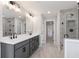 Bathroom featuring gray marble floors, walk-in shower with glass door, and double sink vanity at 2723 Byess Ct, Marietta, GA 30064