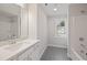 Bathroom with black and white patterned floor, tub, and vanity with quartz countertops at 2723 Byess Ct, Marietta, GA 30064