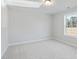 Empty bedroom with a neutral carpet and light-filled window showing a view of trees at 2723 Byess Ct, Marietta, GA 30064