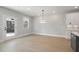 Kitchen dining area features stylish pendant lighting and access to the patio via a glass door at 2723 Byess Ct, Marietta, GA 30064