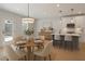 Bright kitchen with island, pendant lights, white cabinets, stainless appliances, and breakfast table set for four at 2723 Byess Ct, Marietta, GA 30064