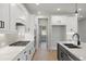 Bright, all-white kitchen with stainless steel appliances, marble countertops, and an island at 2723 Byess Ct, Marietta, GA 30064