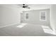 Spacious main bedroom with neutral carpet, two windows, and ceiling fan at 2723 Byess Ct, Marietta, GA 30064