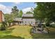 Spacious backyard with deck, patio with fire pit, lawn and lush greenery surrounding the house at 4261 Vineyard Trl, Snellville, GA 30039