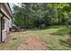 Large backyard features a deck, wooded area, and fire pit, perfect for outdoor relaxation and entertaining at 4261 Vineyard Trl, Snellville, GA 30039