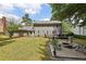 Spacious backyard with deck, patio with fire pit, lawn and lush greenery surrounding the house at 4261 Vineyard Trl, Snellville, GA 30039