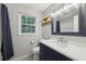 Updated bathroom featuring blue vanity with white countertop, modern mirror and decor at 4261 Vineyard Trl, Snellville, GA 30039