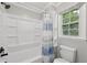 Bright bathroom featuring a tub and shower combo with a window for natural light at 4261 Vineyard Trl, Snellville, GA 30039