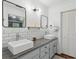 Modern bathroom with double sinks, granite countertop, subway tile backsplash, and ample storage at 4261 Vineyard Trl, Snellville, GA 30039