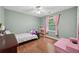 Cozy bedroom with hardwood floors, natural light, and charming decor at 4261 Vineyard Trl, Snellville, GA 30039