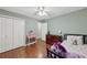 Bright bedroom with hardwood floors, ample closet space, and green walls at 4261 Vineyard Trl, Snellville, GA 30039