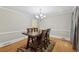 Dining room featuring a wooden table, chair set, and hardwood floors at 4261 Vineyard Trl, Snellville, GA 30039