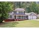 Charming two-story home with gray siding, black shutters, and a well-manicured front lawn at 4261 Vineyard Trl, Snellville, GA 30039