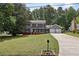 Charming two-story home with gray siding, black shutters, and a well-manicured front lawn at 4261 Vineyard Trl, Snellville, GA 30039
