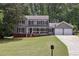 Charming two-story home with gray siding, black shutters, and a welcoming front porch at 4261 Vineyard Trl, Snellville, GA 30039