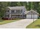Charming two-story home with gray siding, black shutters, a front porch, and a basketball hoop at 4261 Vineyard Trl, Snellville, GA 30039