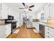 Spacious kitchen with white cabinets, stainless steel appliances, and hardwood floors at 4261 Vineyard Trl, Snellville, GA 30039
