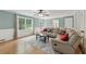 Bright living room with hardwood floors, crown molding, and comfortable sectional sofa at 4261 Vineyard Trl, Snellville, GA 30039