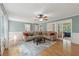 Bright living room with hardwood floors, crown molding, and comfortable sectional sofa at 4261 Vineyard Trl, Snellville, GA 30039