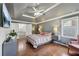 Bright main bedroom with tray ceiling, TV, ensuite bathroom, and closet space for a serene escape at 4261 Vineyard Trl, Snellville, GA 30039